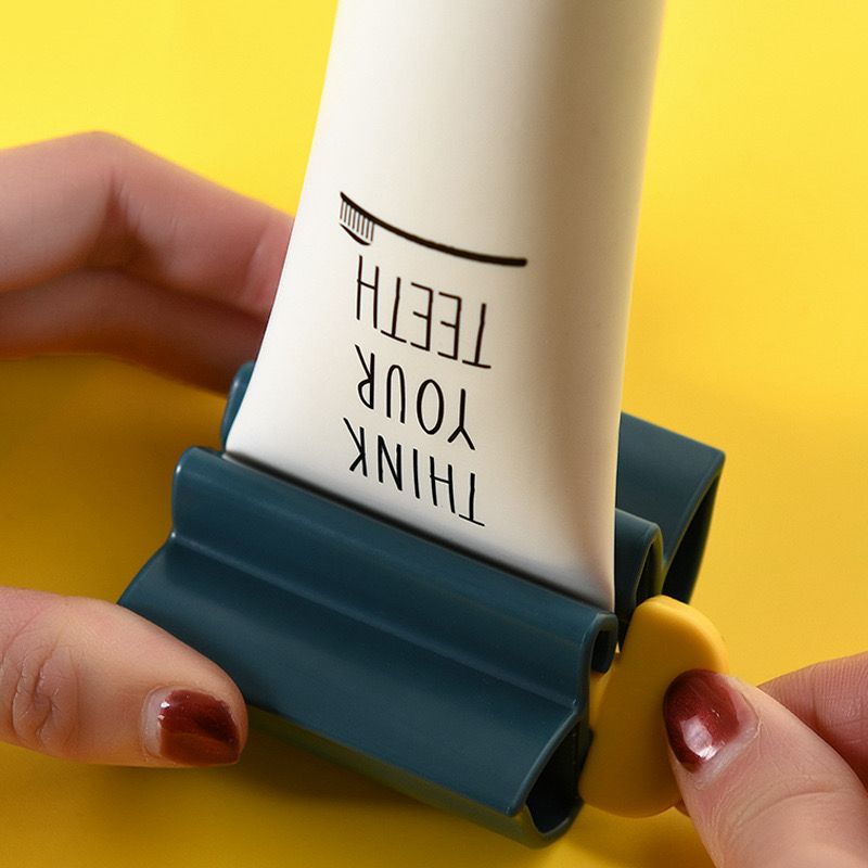 موزع معجون اسنان يدوي دوار لحمله وتوزيعه بسهولة مع مقعد لتثبيته يستخدم لانبوب الاسنان او الكريمات