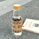 زجاجة مياه 500 ملي بكفر جلد وغطاء خشبي محكم الغلق